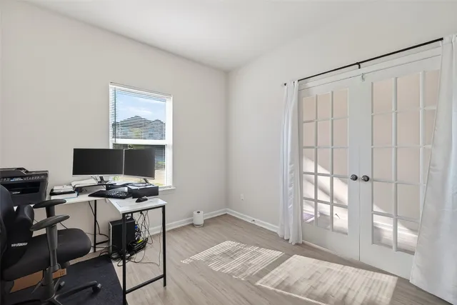 a view of a workspace with furniture and a window