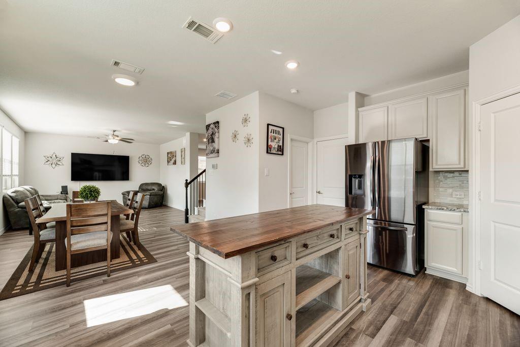 1620 Berry Rdg Trail Aubrey, TX 76227 - Photo 13 of 33 a kitchen with stainless steel appliances granite countertop a refrigerator and a stove top oven