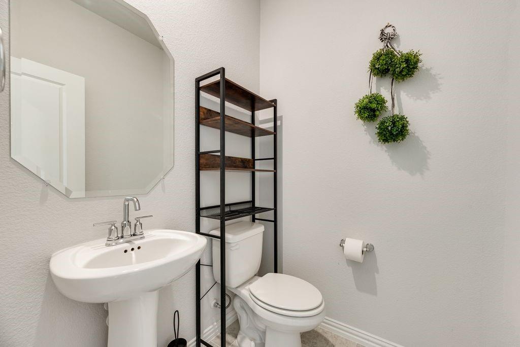 1620 Berry Rdg Trail Aubrey, TX 76227 - Photo 14 of 33 a bathroom with a sink toilet and a mirror