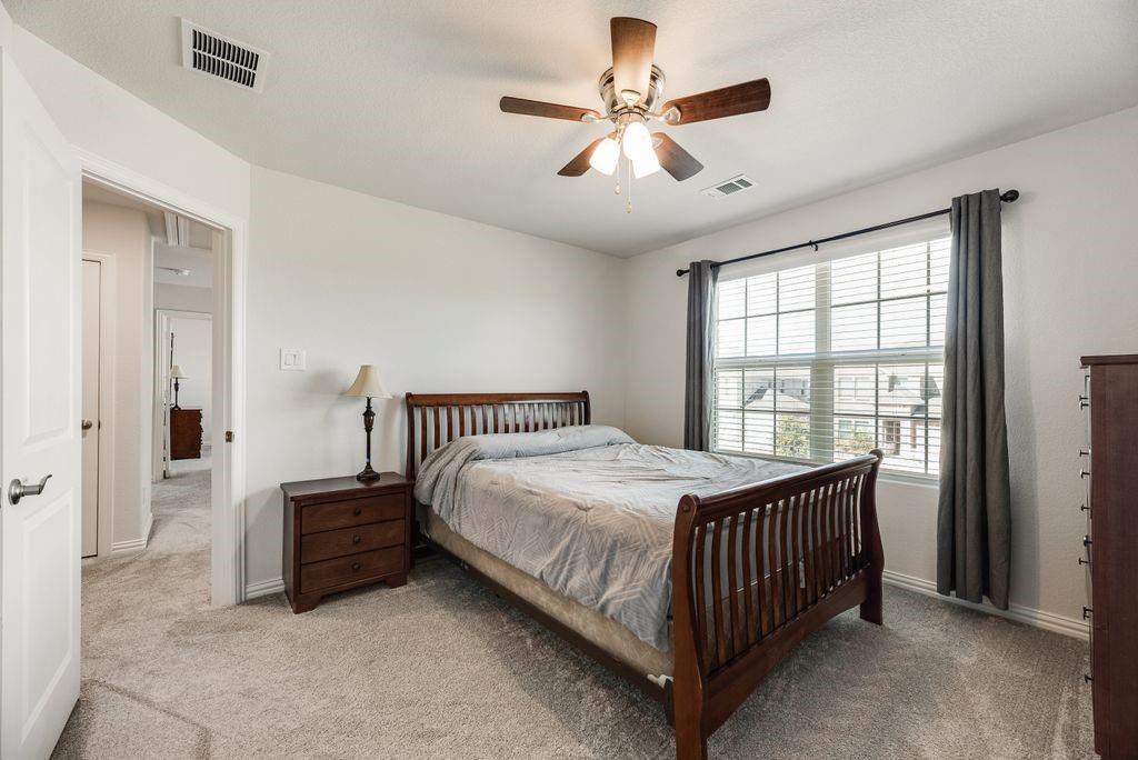 1620 Berry Rdg Trail Aubrey, TX 76227 - Photo 16 of 33 a bedroom with a bed and a large window