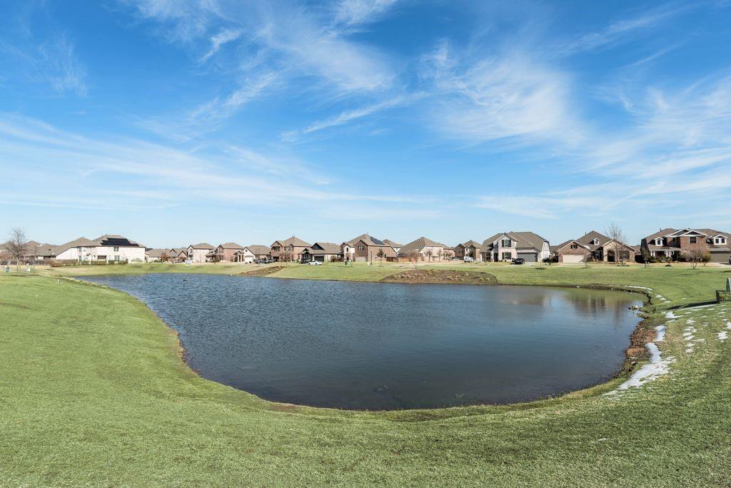 1620 Berry Rdg Trail Aubrey, TX 76227 - Photo 28 of 33 a view of a lake with a houses in the background