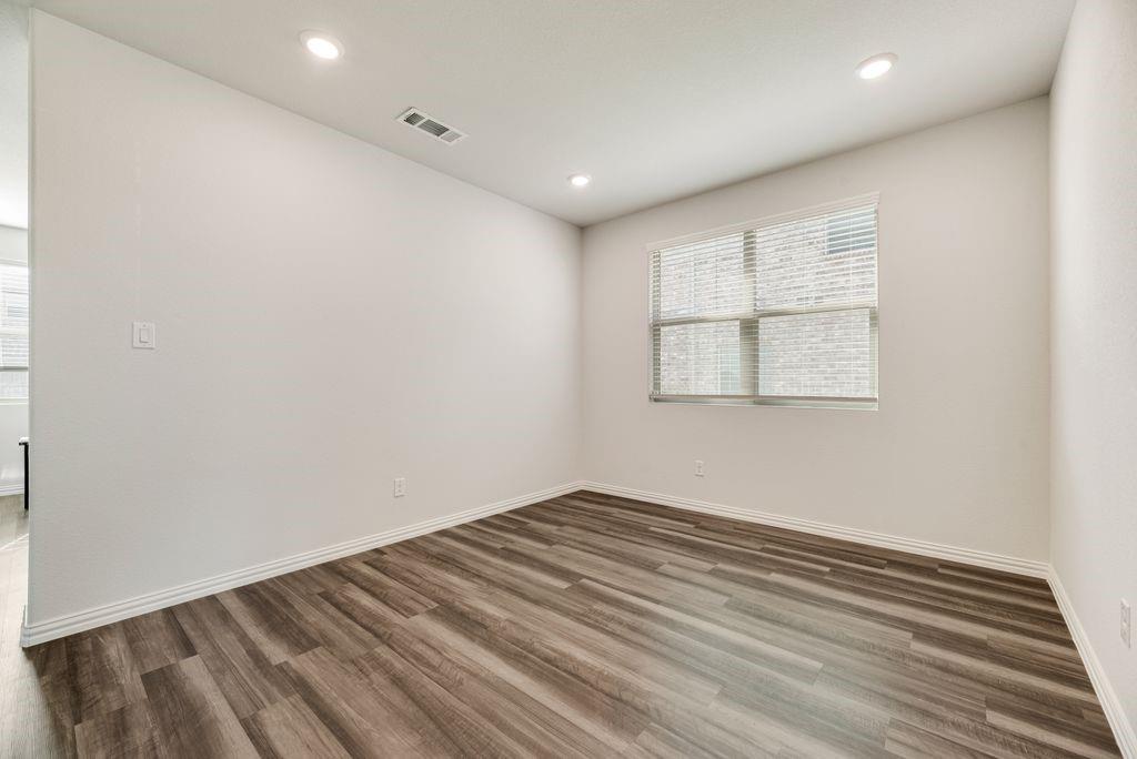 1620 Berry Rdg Trail Aubrey, TX 76227 - Photo 6 of 33 an empty room with wooden floor and windows