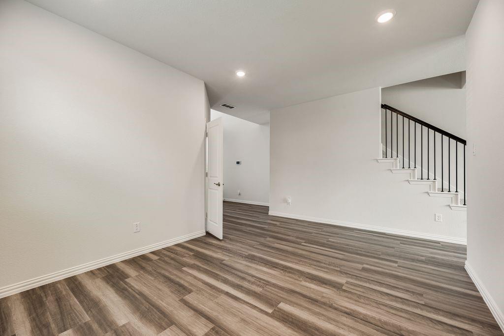 1620 Berry Rdg Trail Aubrey, TX 76227 - Photo 7 of 33 an empty room with wooden floor and windows