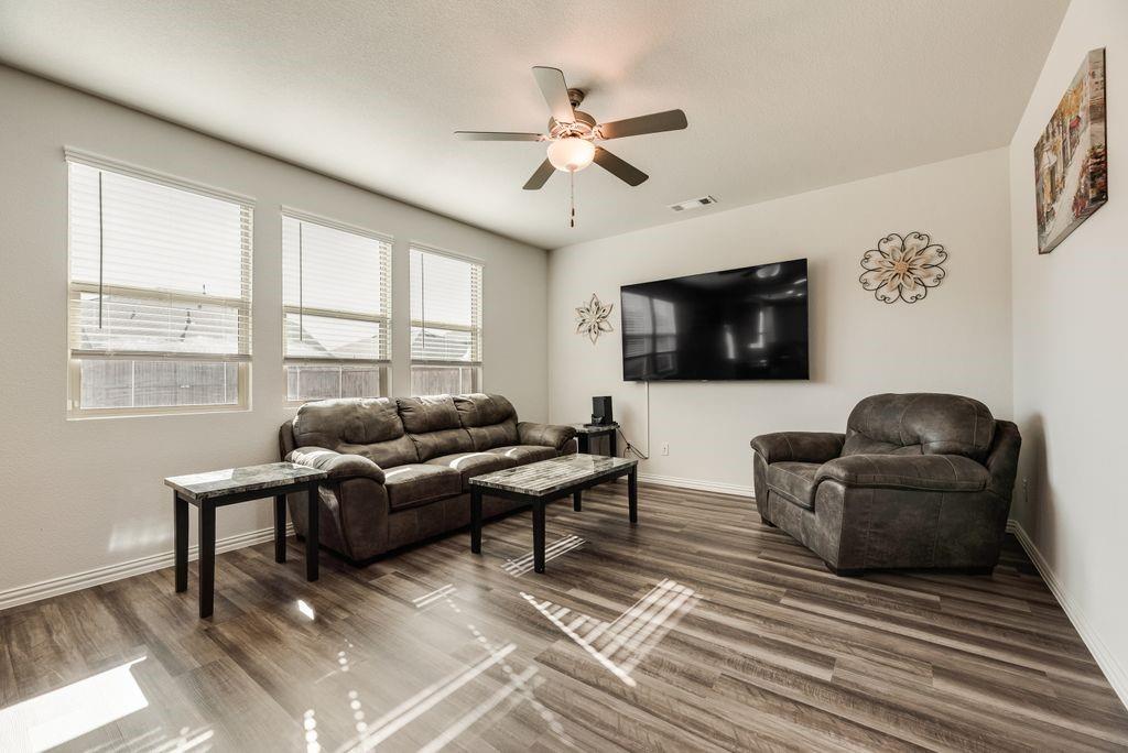 1620 Berry Rdg Trail Aubrey, TX 76227 - Photo 8 of 33 a living room with furniture a flat screen tv and a window