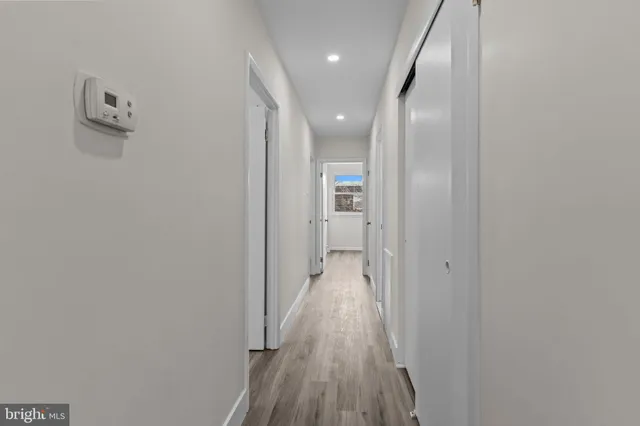 a view of hallway with wooden floor