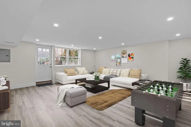 a view of an empty room with wooden floor and windows