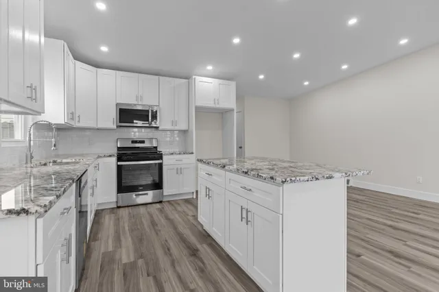 a kitchen with a stove a sink and a refrigerator