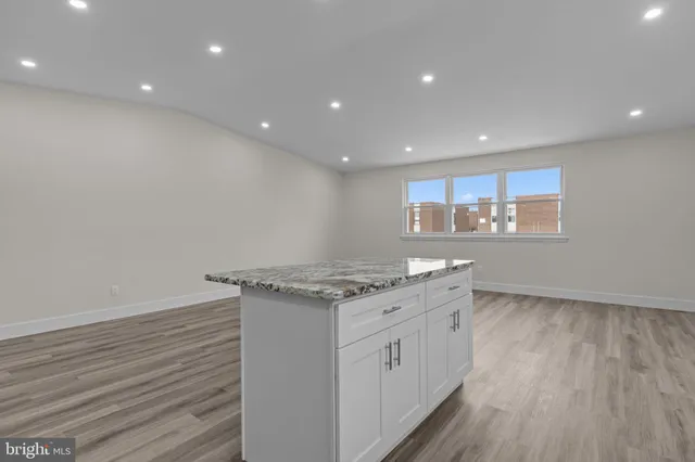 a kitchen with a stove and white cabinets
