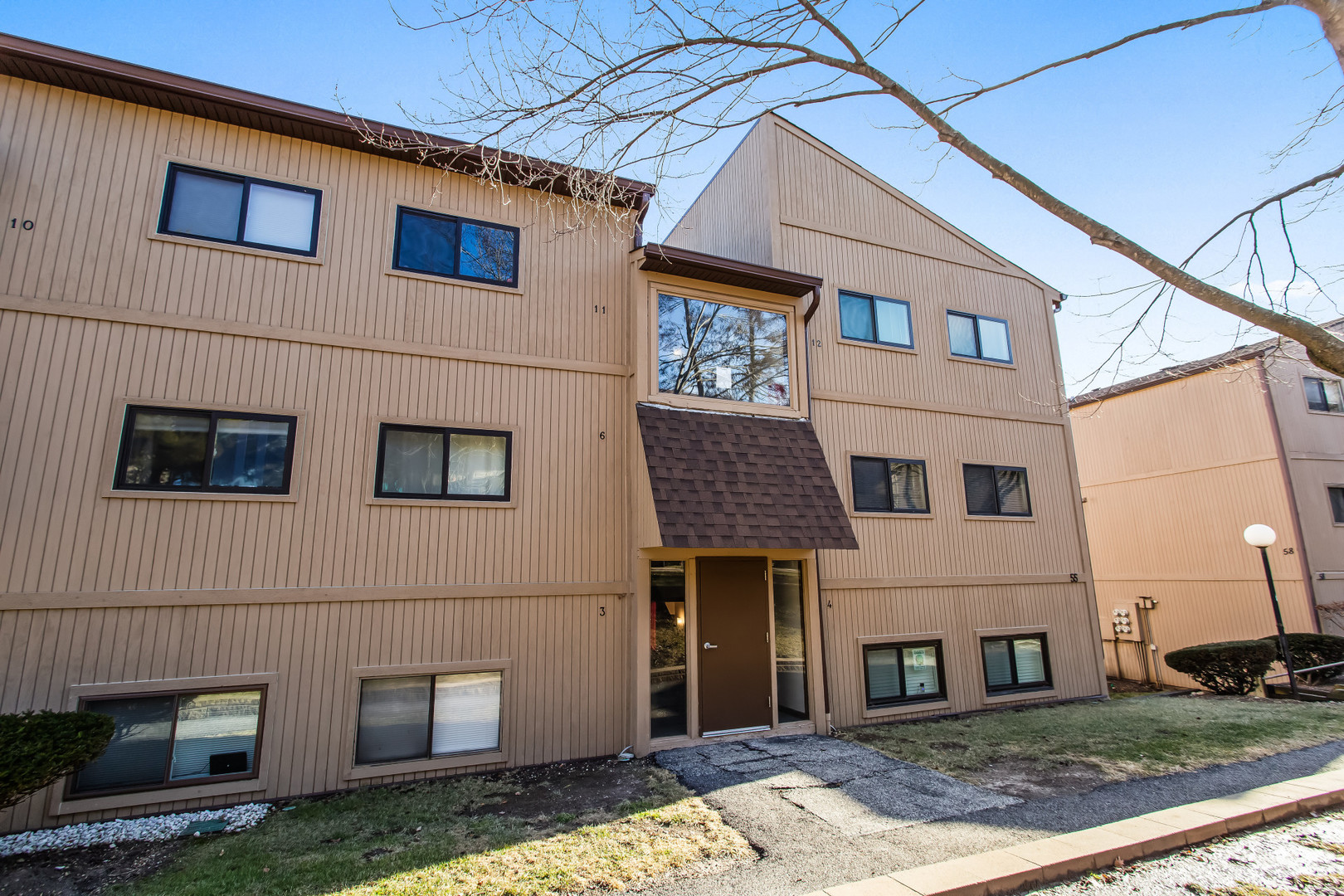 55 Vail Colony, Unit 6 Fox Lake, IL 60020 - Photo 20 of 23 a front view of a house with garden