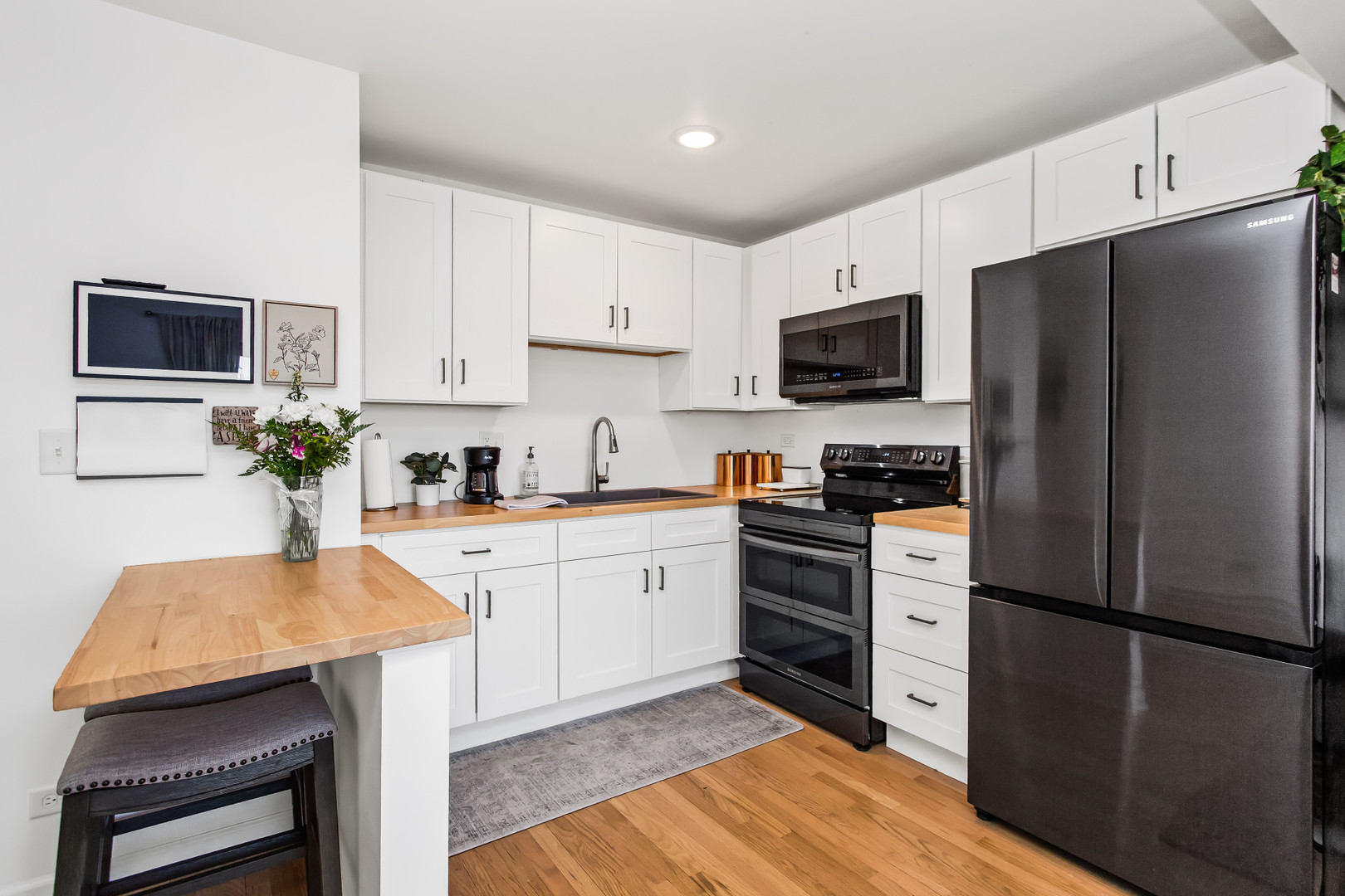 55 Vail Colony, Unit 6 Fox Lake, IL 60020 - Photo 3 of 23 a kitchen with stainless steel appliances a refrigerator stove microwave and cabinets