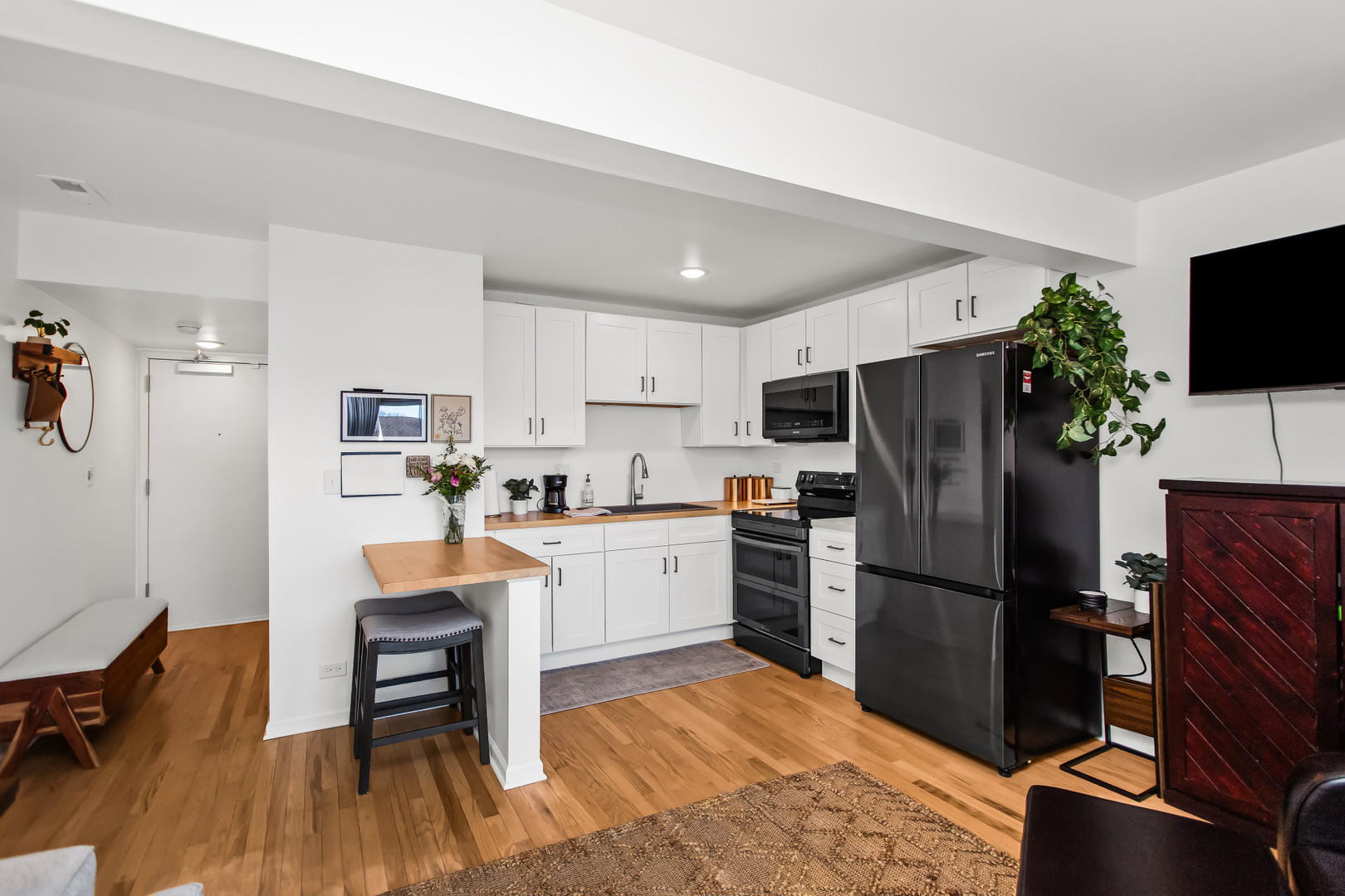 55 Vail Colony, Unit 6 Fox Lake, IL 60020 - Photo 4 of 23 a kitchen with white cabinets and stainless steel appliances