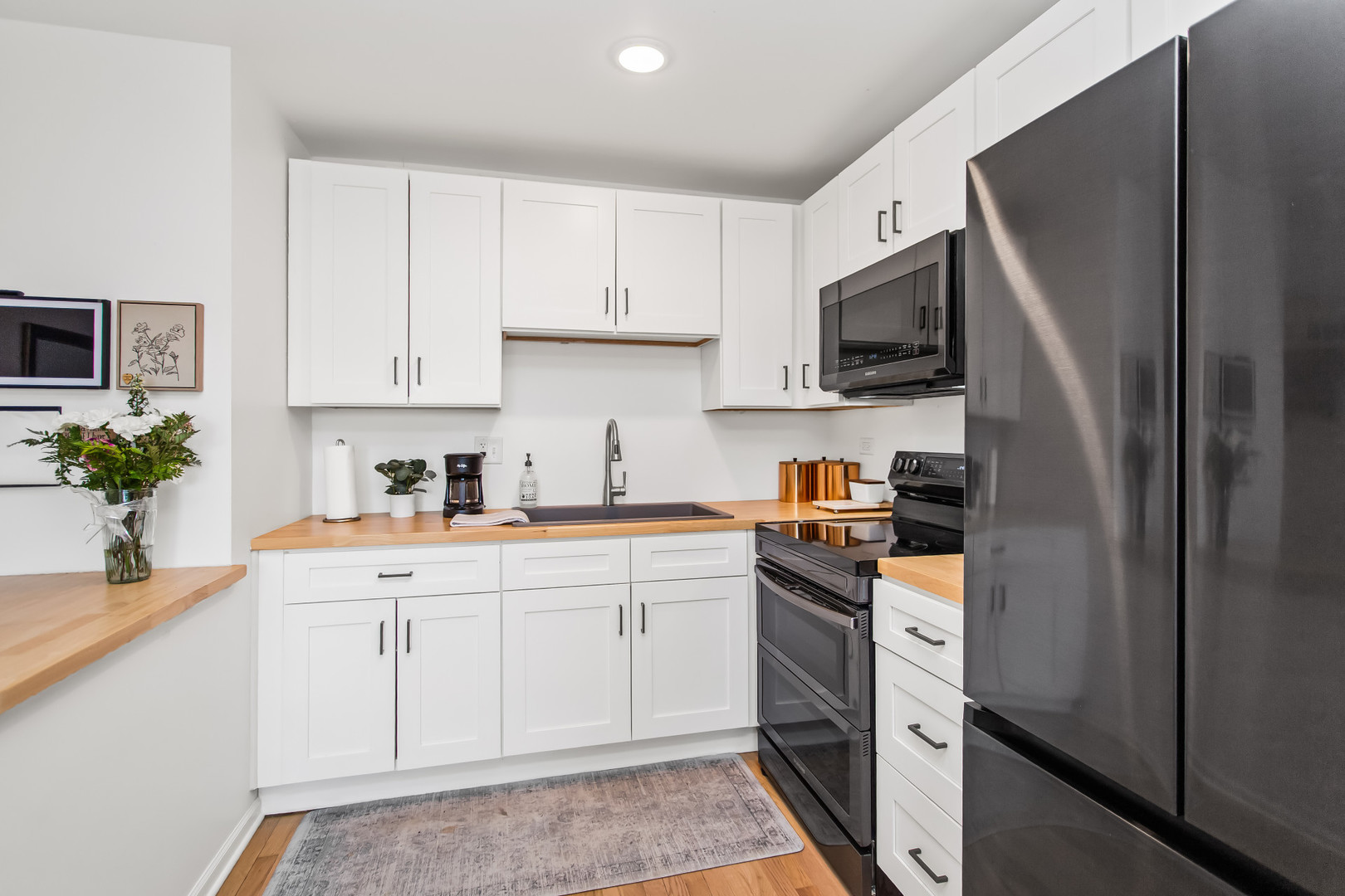 55 Vail Colony, Unit 6 Fox Lake, IL 60020 - Photo 6 of 23 a kitchen with stainless steel appliances granite countertop a refrigerator sink and stove