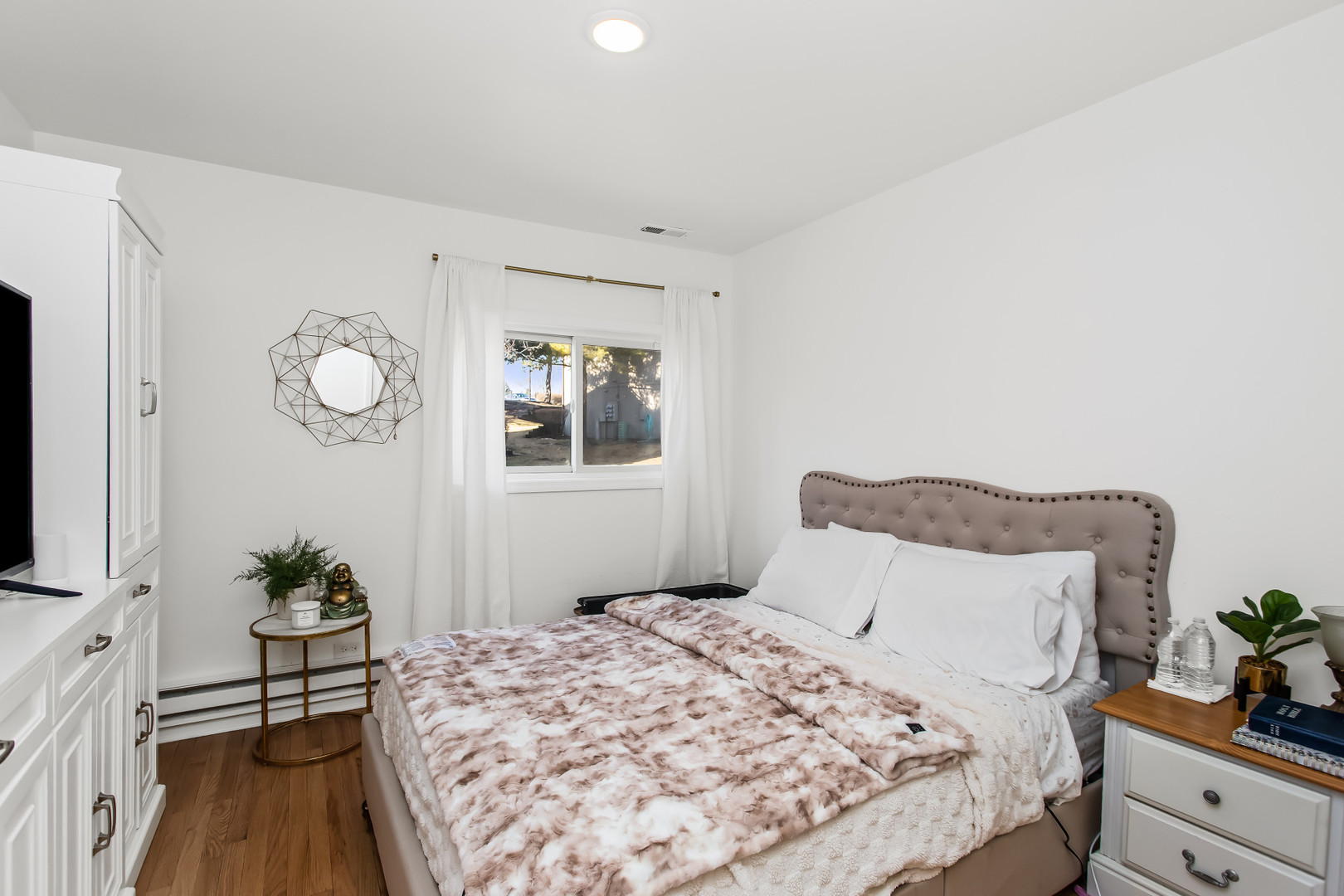55 Vail Colony, Unit 6 Fox Lake, IL 60020 - Photo 7 of 23 a bedroom with a bed and a flat tv screen on dresser