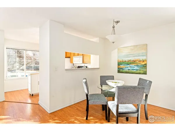 a dining room with furniture a rug and a painting