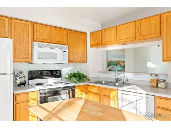 a kitchen with stainless steel appliances kitchen island granite countertop a sink and a granite counter tops