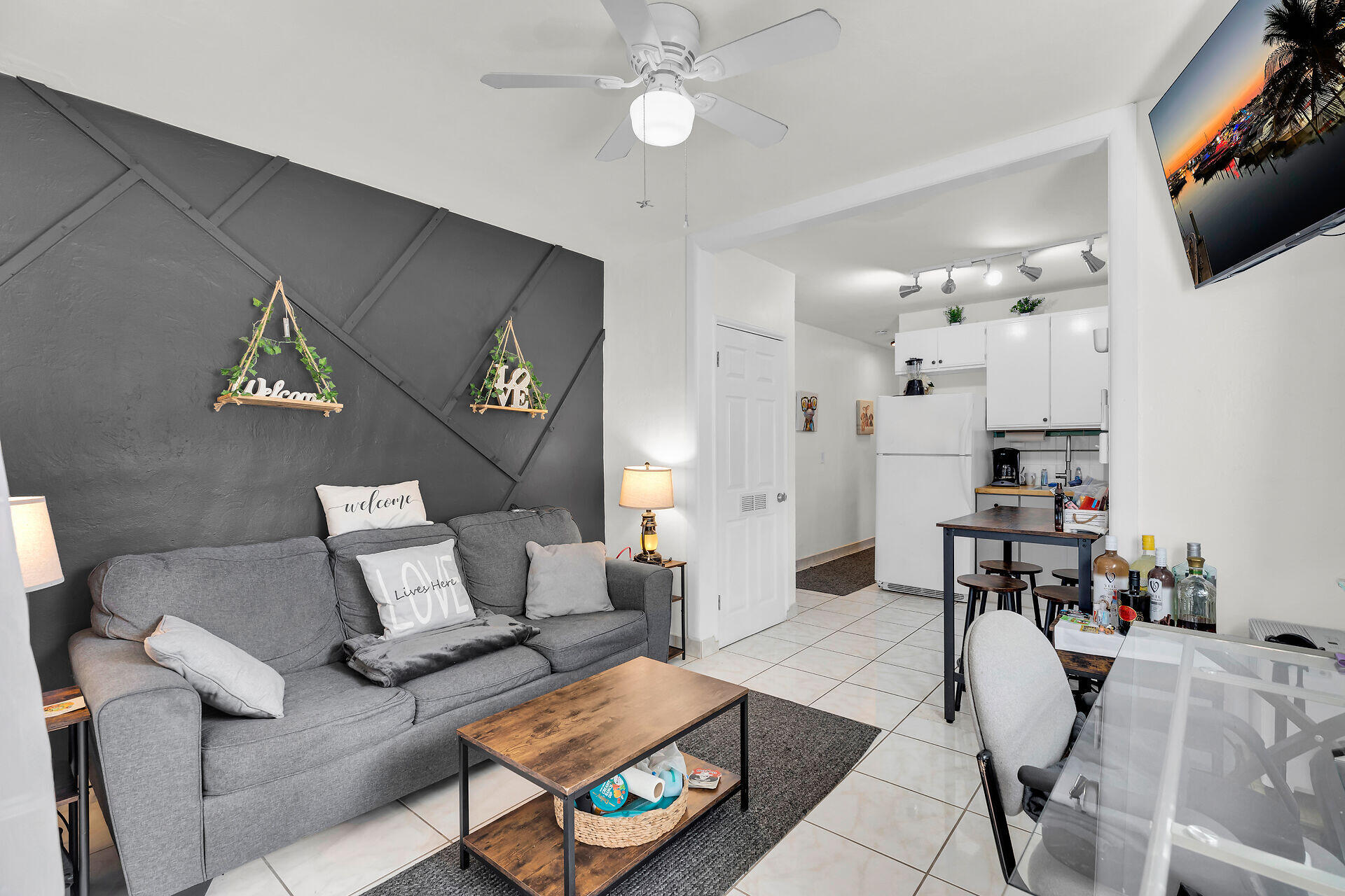 1119 Simonton Street, Unit A1 Key West, FL 33040 - Photo 5 of 18 a living room with furniture and a chandelier