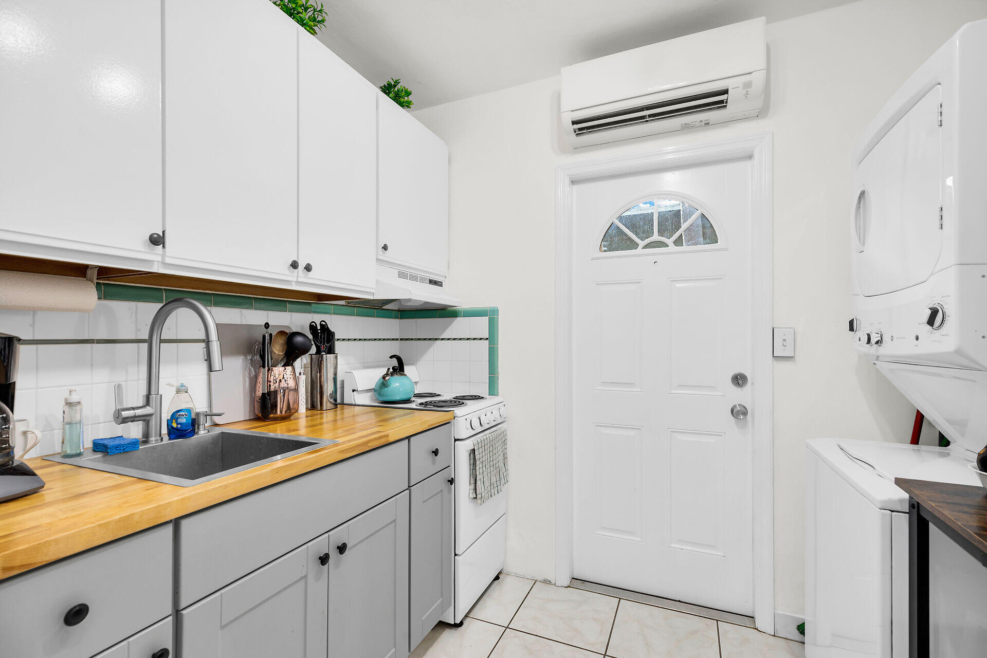 1119 Simonton Street, Unit A1 Key West, FL 33040 - Photo 8 of 18 a kitchen with stainless steel appliances white cabinets and a refrigerator