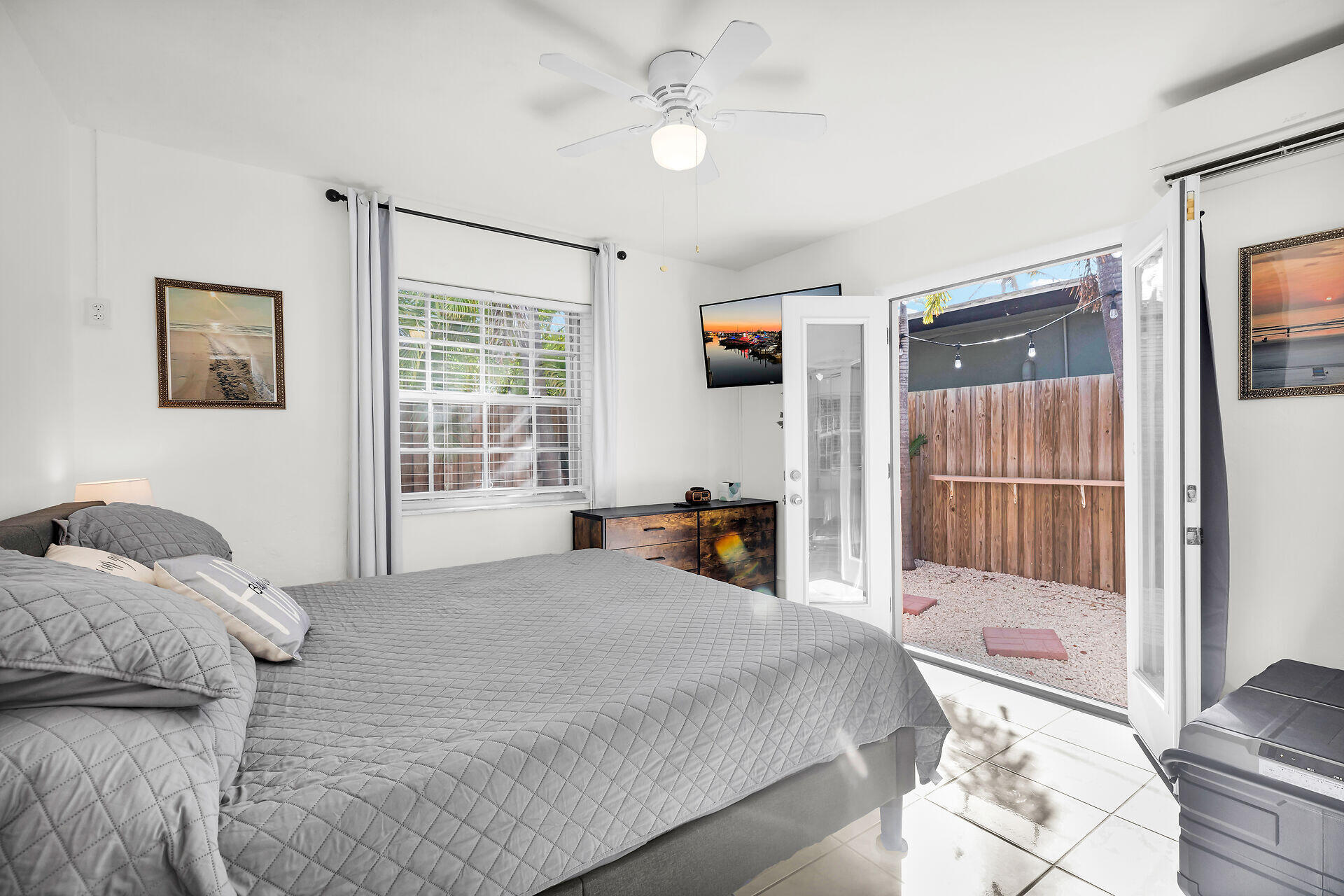 1119 Simonton Street, Unit A1 Key West, FL 33040 - Photo 10 of 18 a bedroom with a bed and a flat tv screen