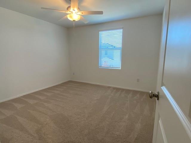 3232 Peyton Lila Road Dallas, TX 75212 - Photo 14 of 17 an empty room with a chandelier fan and windows