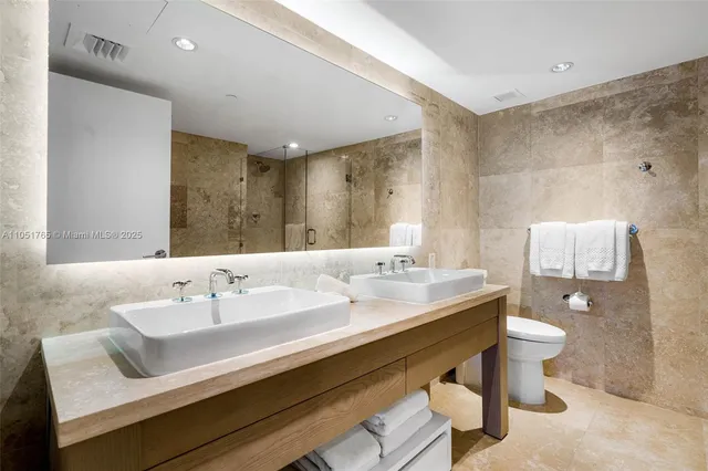 a bathroom with a sink double vanity and a toilet