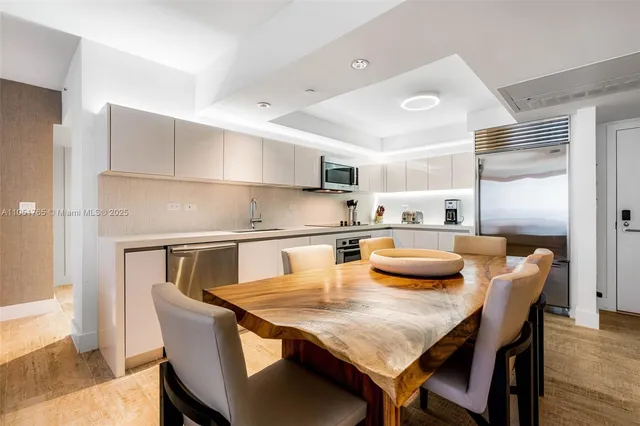 a kitchen with granite countertop kitchen island stainless steel appliances a sink and counter space