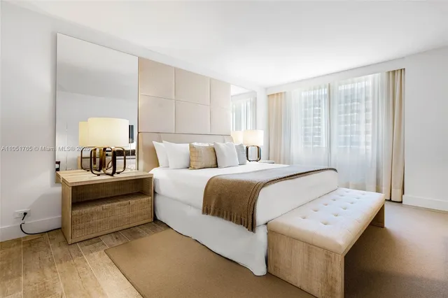 a bedroom with a bed and a lamp on table