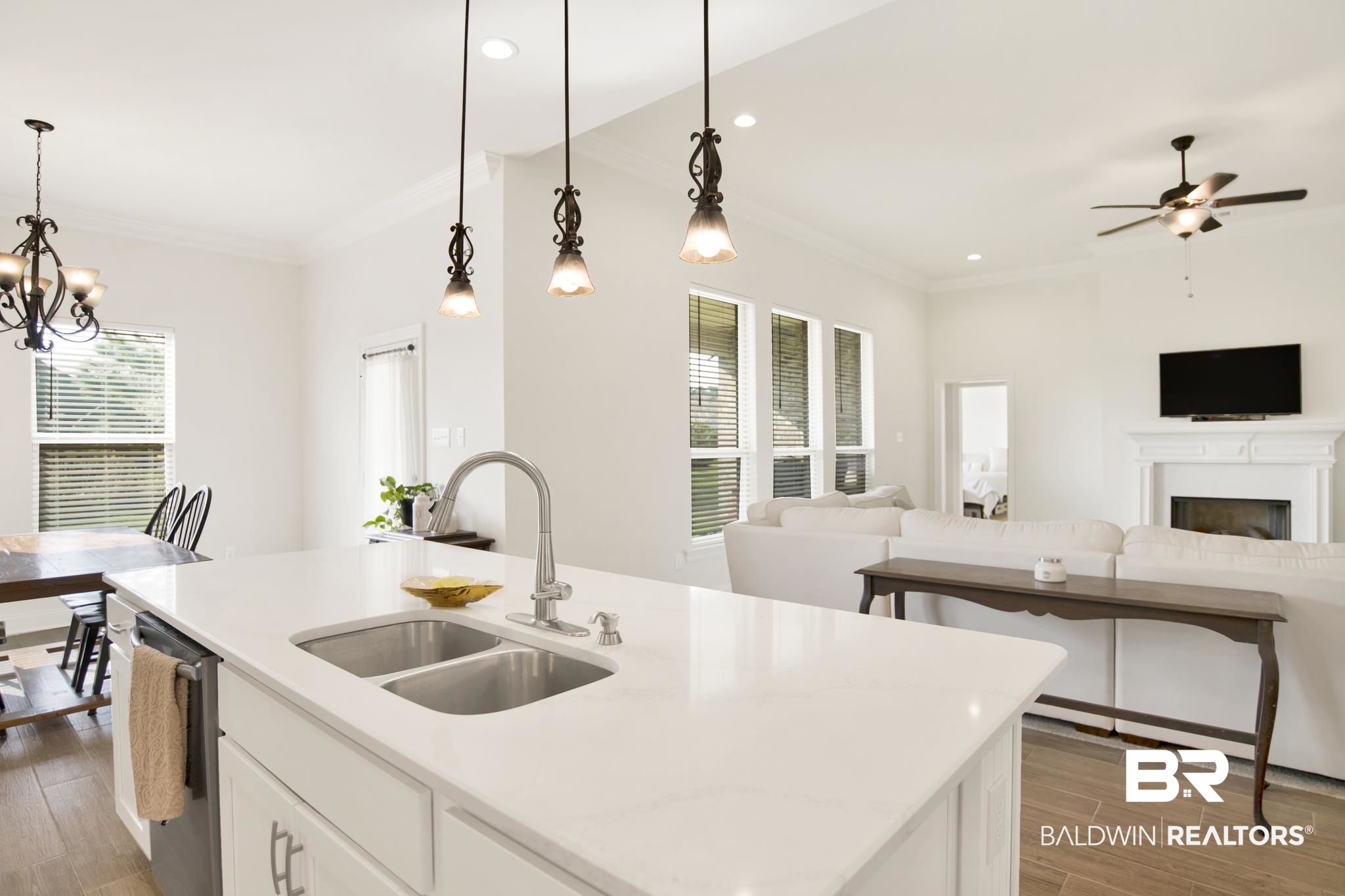 22258 Hibiscus Circle Foley, AL 36535 - Photo 25 of 26 Kitchen with a sink, open floor plan, dishwasher, crown molding, and light wood-type flooring