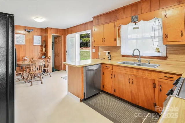 a kitchen with stainless steel appliances granite countertop sink stove and white cabinets