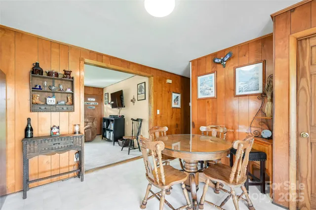 a dining room with furniture and a window