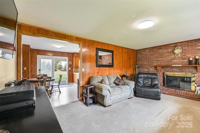 a living room with furniture fireplace and flat screen tv