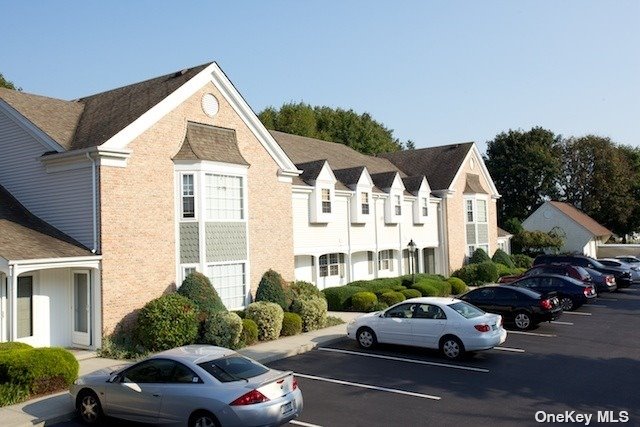 a view of cars parked in front of a house