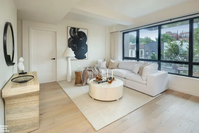a living room with furniture and a floor to ceiling window