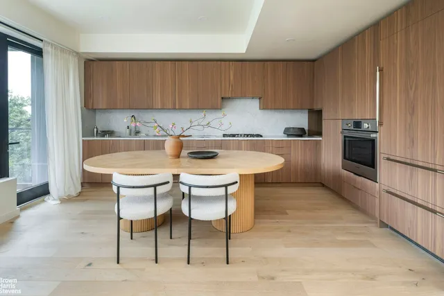 a kitchen with a sink cabinets and window