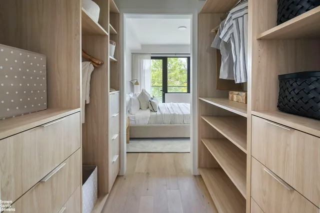 a view of walk in closet and bedroom