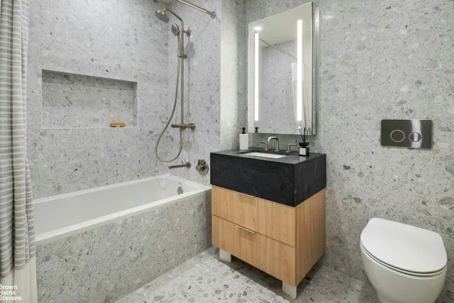a bathroom with a tub a sink and a toilet