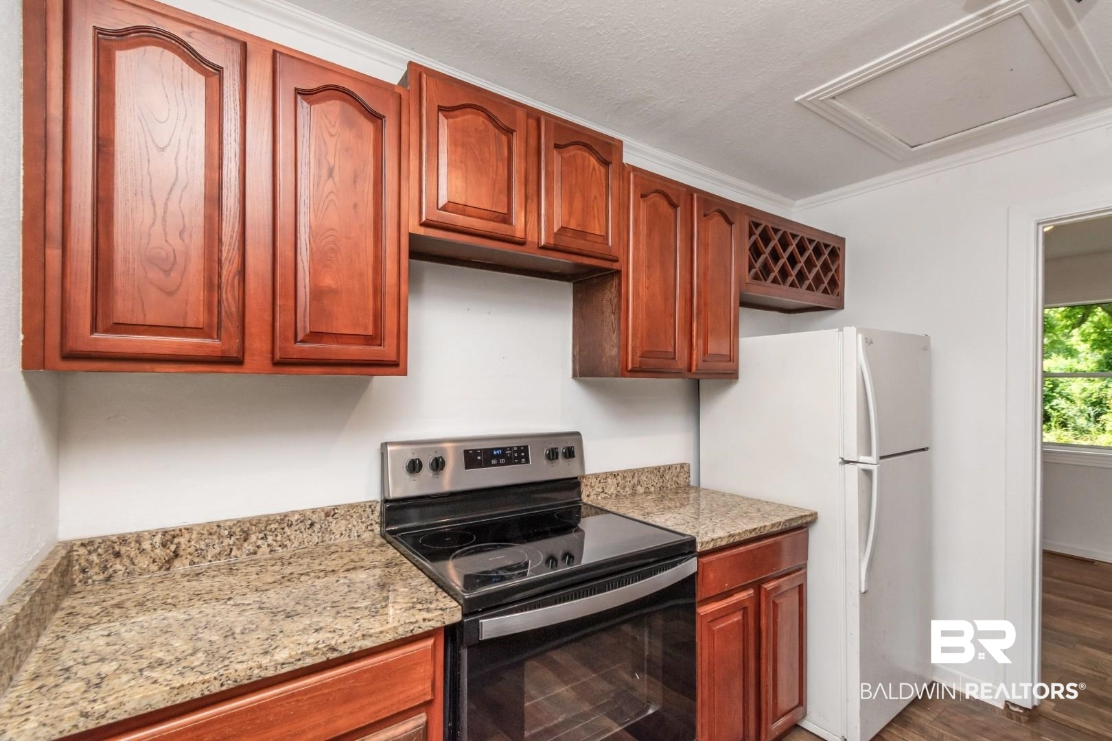 2905A McFarland Road, Unit F Mobile, AL 36695 - Photo 11 of 29 Kitchen featuring wood cabinetry, stone countertops, a stainless steel electric range, and a built-in wine rack