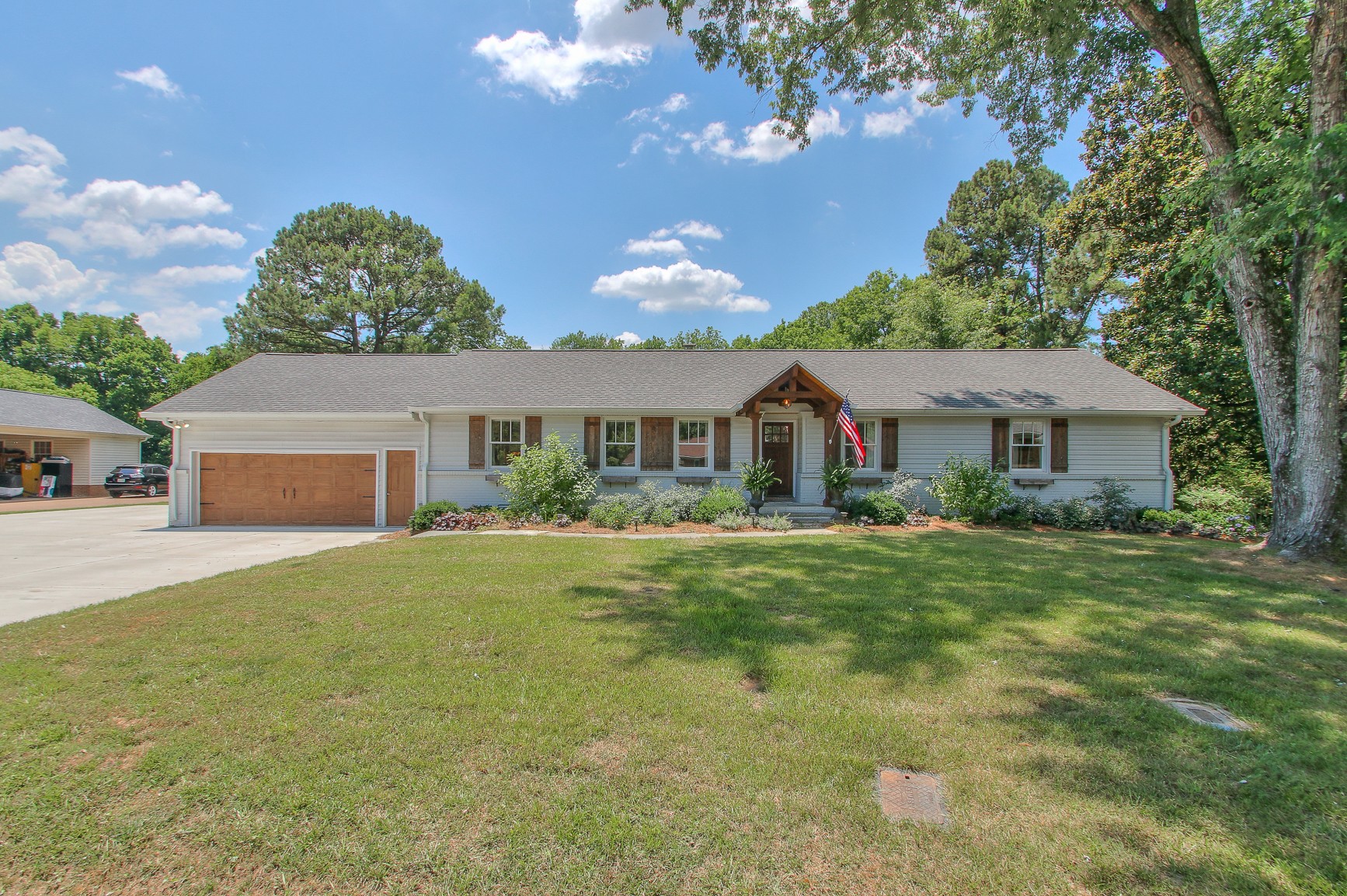 a front view of house with yard and green space