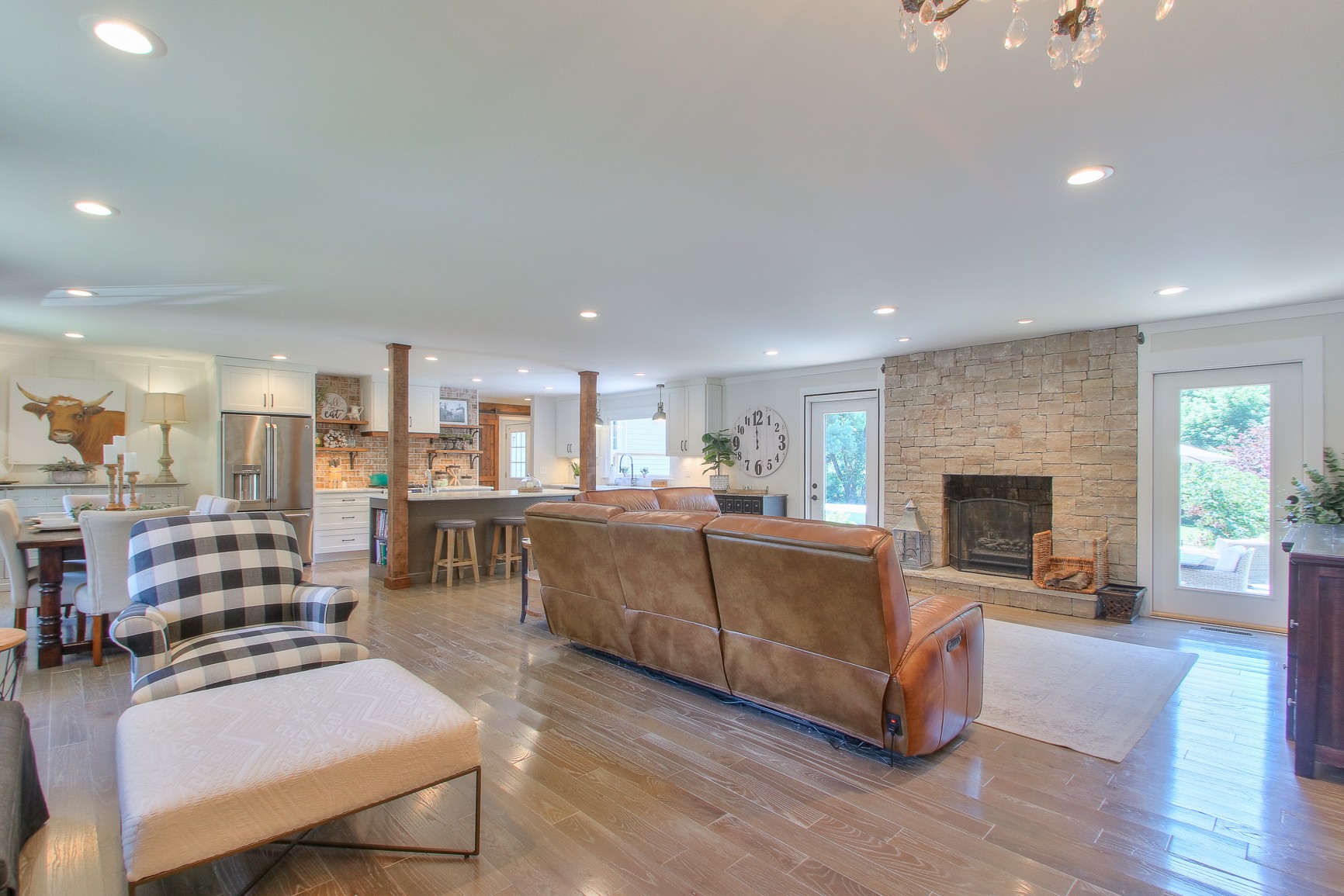 183 Lancaster Drive Franklin, TN 37064 - Photo 2 of 50 a living room with furniture a fireplace and a kitchen view