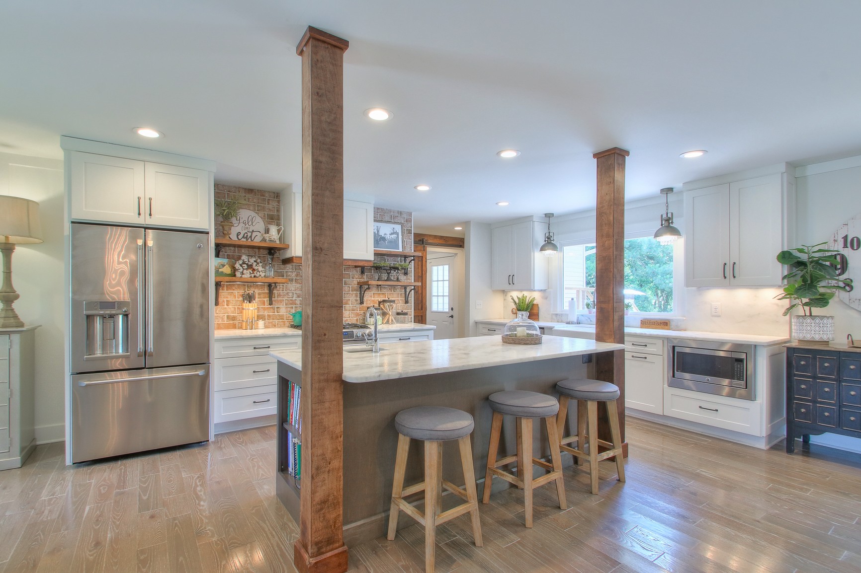 183 Lancaster Drive Franklin, TN 37064 - Photo 10 of 50 a kitchen with stainless steel appliances granite countertop a refrigerator a stove a sink a dining table and chairs with wooden floor