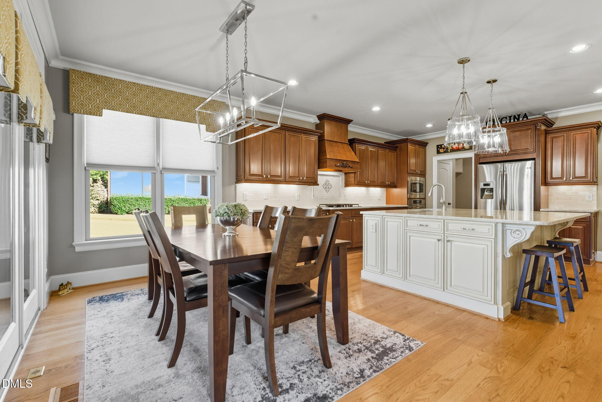 2603 Peachleaf Street Raleigh, NC 27614 - Photo 31 of 90 a kitchen with kitchen island a dining table and appliances