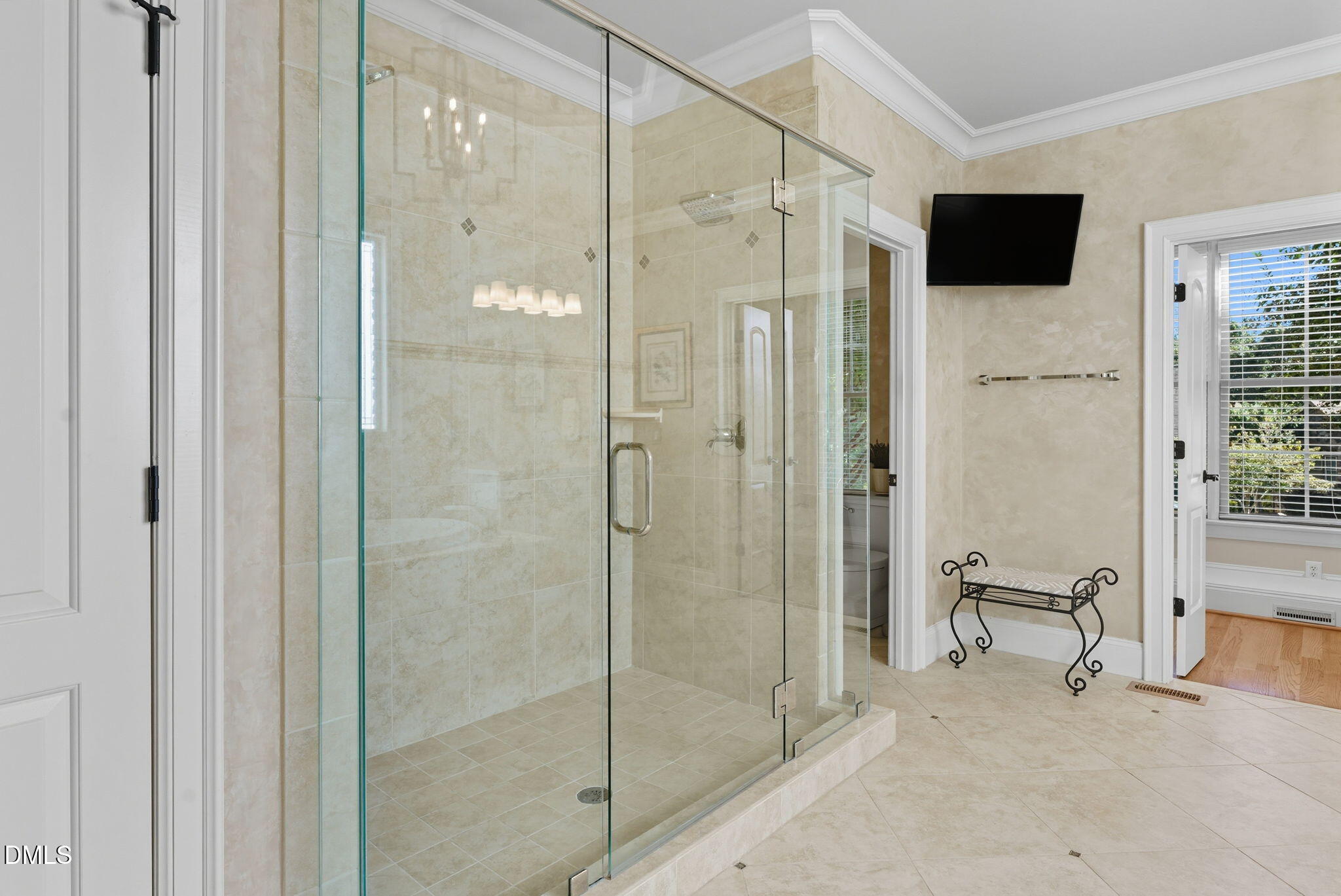 2603 Peachleaf Street Raleigh, NC 27614 - Photo 46 of 90 a bathroom with a shower and a flat screen tv