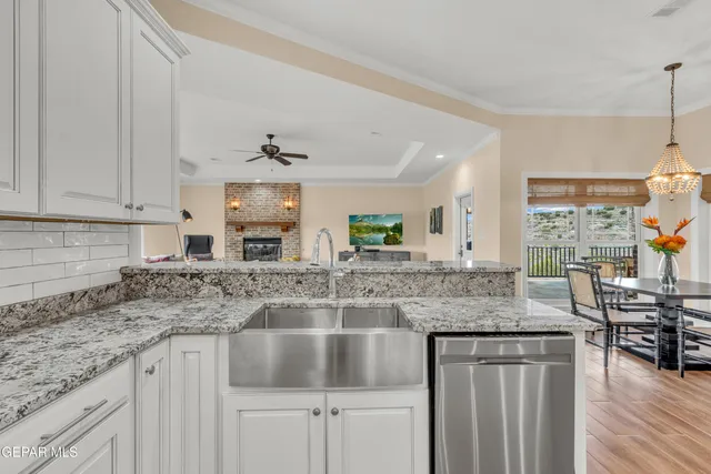 a kitchen with stainless steel appliances granite countertop a sink and cabinets