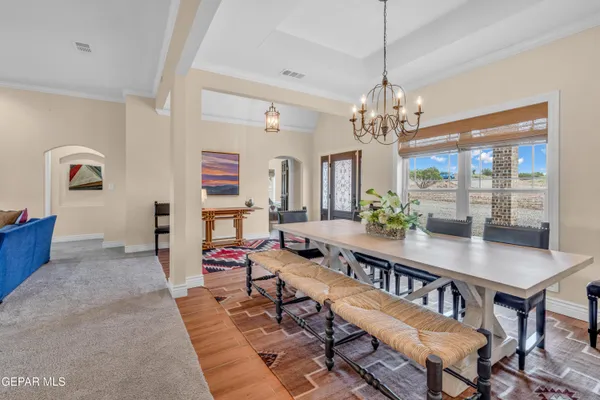 a living room with fireplace furniture and a chandelier