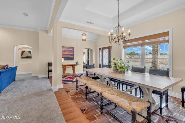 a living room with fireplace furniture and a chandelier