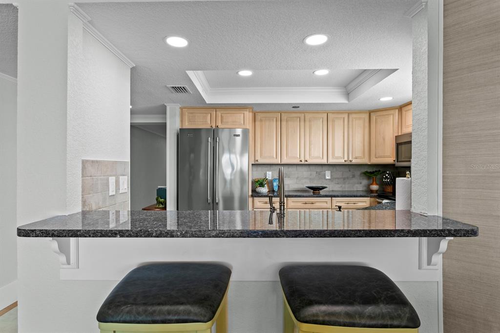 16332 Gulf Boulevard, Unit 3B Redington Beach, FL 33708 - Photo 22 of 91 a kitchen with stainless steel appliances granite countertop a refrigerator a sink dishwasher a refrigerator and a stove