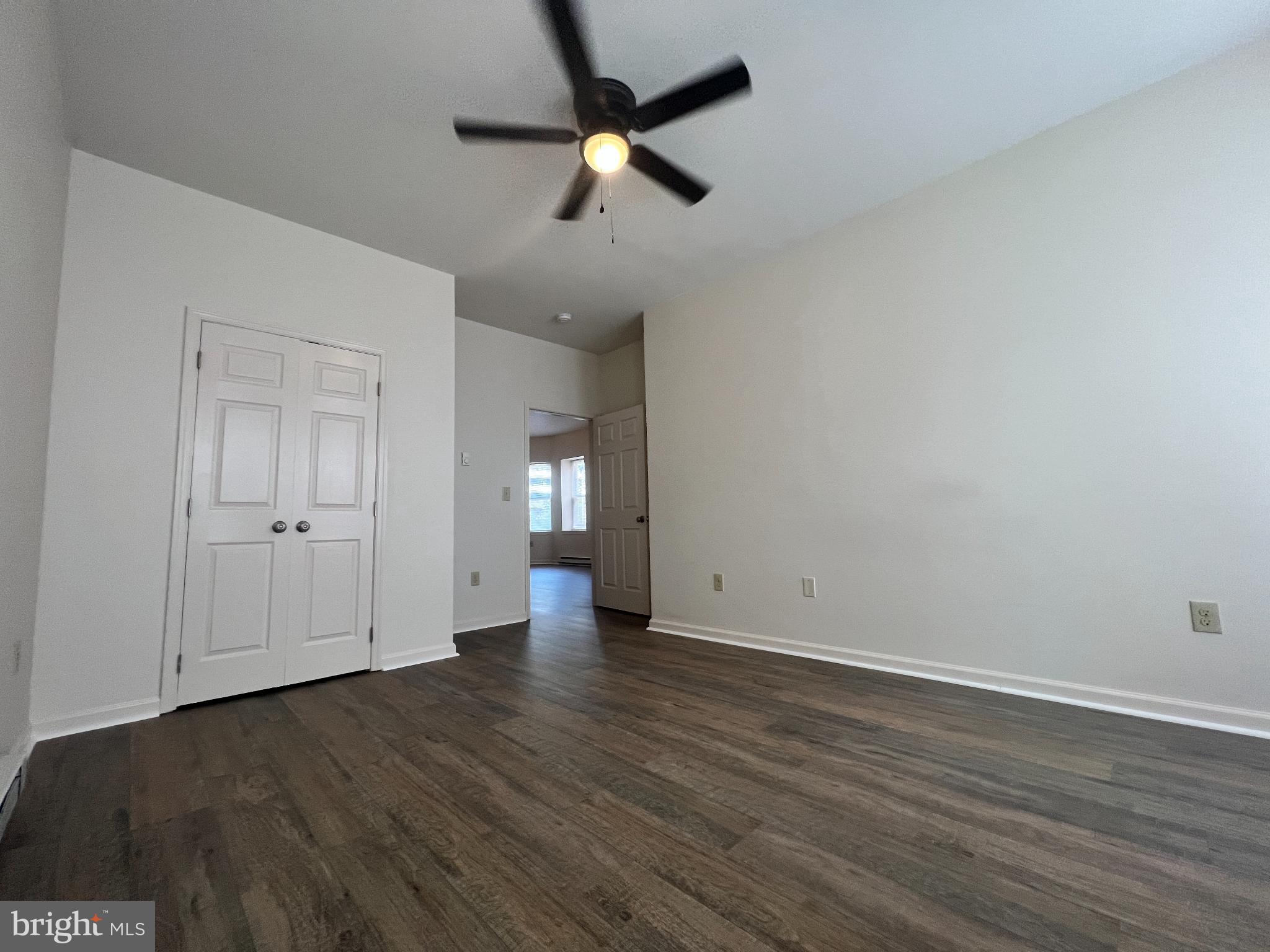 255 South Potomac Street, Unit 2 Hagerstown, MD 21740 - Photo 11 of 18 an empty room with wooden floor ceiling fan and windows