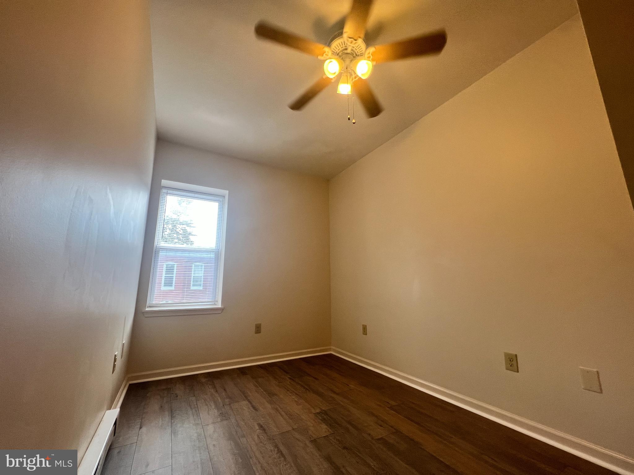 255 South Potomac Street, Unit 2 Hagerstown, MD 21740 - Photo 12 of 18 an empty room with wooden floor and windows