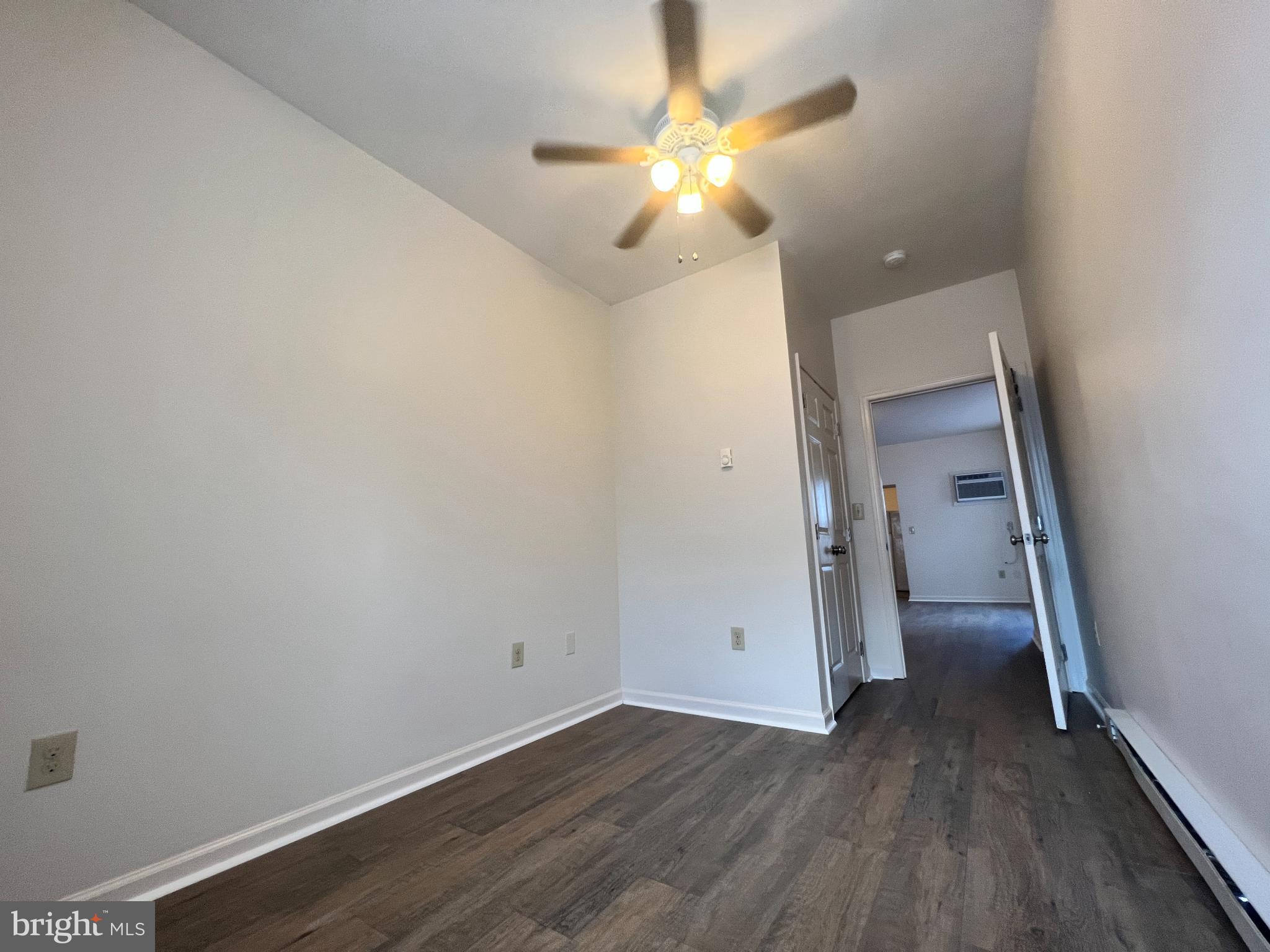 255 South Potomac Street, Unit 2 Hagerstown, MD 21740 - Photo 13 of 18 an empty room with wooden floor and fan