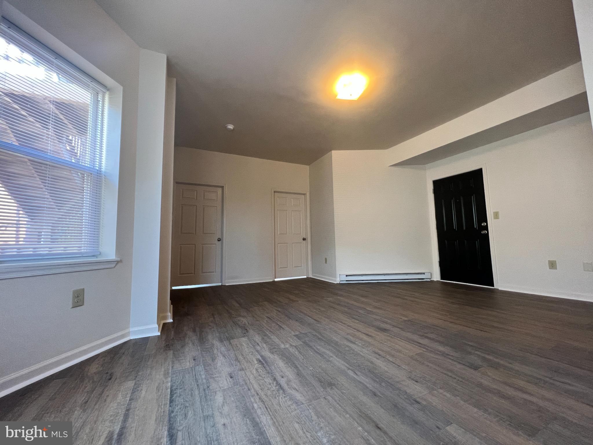 255 South Potomac Street, Unit 2 Hagerstown, MD 21740 - Photo 14 of 18 a view of an empty room with wooden floor and windows