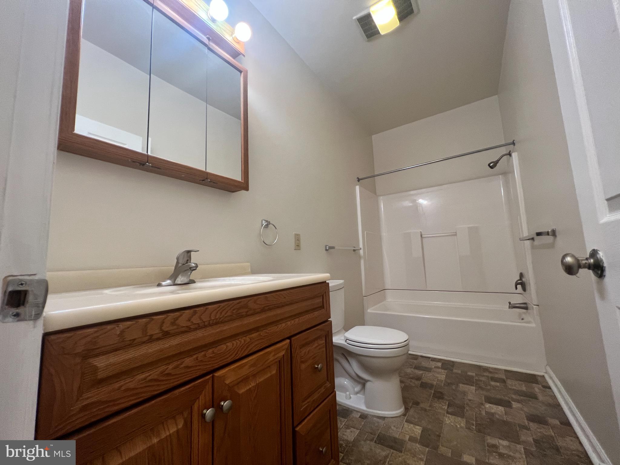 255 South Potomac Street, Unit 2 Hagerstown, MD 21740 - Photo 15 of 18 a bathroom with a sink a toilet and a mirror